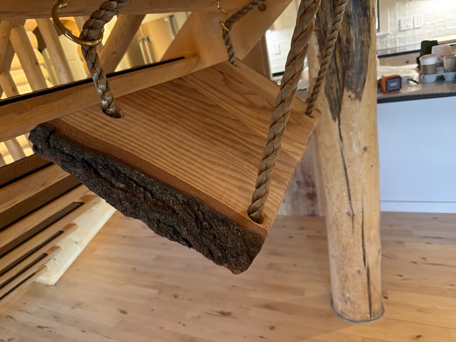 Live-edge wood swing seat suspended with rope