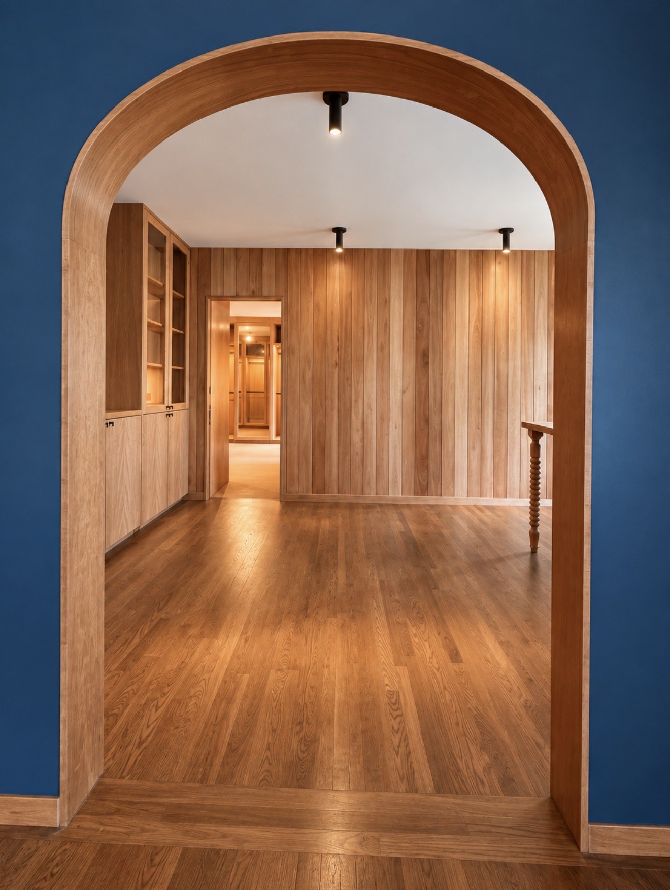 Arched wood doorway and fitted wall panels