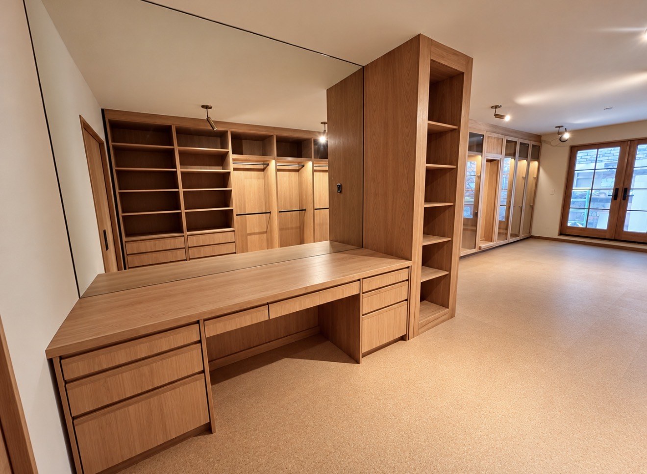 Wood dressing room desk, drawers, and surrounding shelving