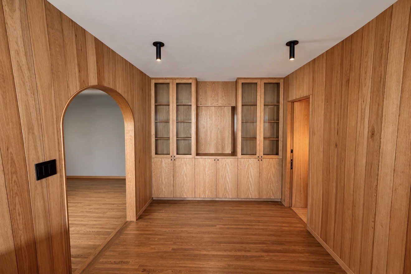 Wood wall panels, arched doorway, and inset display cabinets
