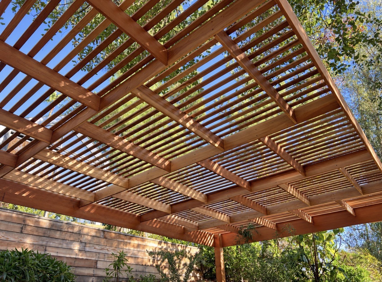Wood pergola beams and slats viewed from below