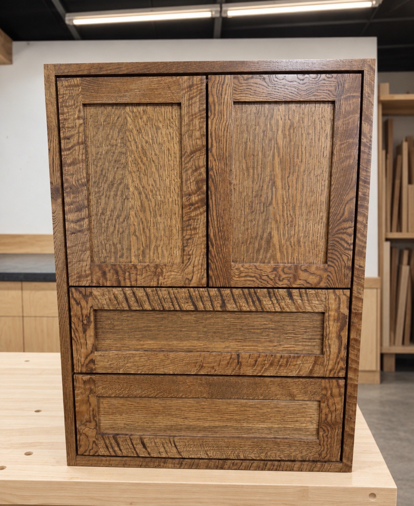Oak cabinet with paneled doors and stacked drawer fronts
